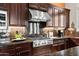 Gourmet kitchen with stainless steel appliances, custom cabinetry, and granite countertops at 41809 N La Crosse Trl, Anthem, AZ 85086