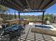 Cozy outdoor kitchen and pergola with seating area, perfect for outdoor entertaining with beautiful desert views at 41809 N La Crosse Trl, Anthem, AZ 85086