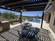 Outdoor kitchen, dining, fire pit, and pool create a relaxing area with desert landscaping and mountain views at 41809 N La Crosse Trl, Anthem, AZ 85086