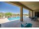 Back patio overlooking the pool offers beautiful desert views and outdoor lounging space at 41809 N La Crosse Trl, Anthem, AZ 85086