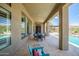 Inviting covered patio with a dining area, pool, and desert landscape views at 41809 N La Crosse Trl, Anthem, AZ 85086