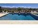 Backyard pool with travertine tile and water feature with desert views at 41809 N La Crosse Trl, Anthem, AZ 85086
