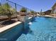 Inviting pool featuring stone accents, lush desert foliage, and refreshing water features at 41809 N La Crosse Trl, Anthem, AZ 85086