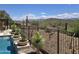 The backyard pool has desert landscape views and a wrought iron fence at 41809 N La Crosse Trl, Anthem, AZ 85086