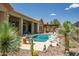 Inviting backyard featuring a pool, outdoor dining area, and desert landscaping, perfect for relaxation and entertainment at 41809 N La Crosse Trl, Anthem, AZ 85086