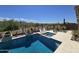 Beautiful sparkling pool with jacuzzi spa, desert landscaping, and comfortable outdoor seating at 41809 N La Crosse Trl, Anthem, AZ 85086