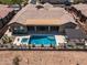 Backyard pool with covered patio, lounge area, and well-maintained landscaping at 41809 N La Crosse Trl, Anthem, AZ 85086