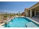 Inviting pool with water features and an adjacent spa, nestled in a desert landscape next to the home at 41809 N La Crosse Trl, Anthem, AZ 85086