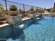 Inviting pool featuring stone accents, lush desert foliage, and refreshing water features at 41809 N La Crosse Trl, Anthem, AZ 85086