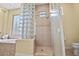 Glass block shower with beige tile surround near soaking tub at 41809 N La Crosse Trl, Anthem, AZ 85086