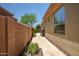 Paver side yard with block wall offering privacy, showcasing low-maintenance desert landscaping and home exterior at 41809 N La Crosse Trl, Anthem, AZ 85086