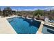 Serene backyard oasis with a stunning swimming pool, spa, desert plants, and picturesque mountain views at 41809 N La Crosse Trl, Anthem, AZ 85086