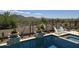 Beautiful swimming pool and spa with comfortable lounge seating, desert landscaping, and mountain views at 41809 N La Crosse Trl, Anthem, AZ 85086
