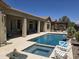 Inviting backyard pool with a covered patio, barbecue, desert views, and ample space for relaxation at 41809 N La Crosse Trl, Anthem, AZ 85086