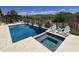 Sparkling swimming pool and spa with lounge seating, desert landscaping, and picturesque mountain views at 41809 N La Crosse Trl, Anthem, AZ 85086