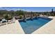 Inviting pool and spa featuring water features, lounge chairs, and desert landscaping with mountain views at 41809 N La Crosse Trl, Anthem, AZ 85086