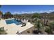 A stunning swimming pool surrounded by desert landscaping offering a tranquil retreat and breathtaking views at 41809 N La Crosse Trl, Anthem, AZ 85086