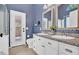 Well-lit bathroom with double sink vanity, stylish mirrors, and outdoor access to the backyard at 4350 E Gatewood Dr, Phoenix, AZ 85050