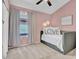 Charming bedroom featuring vaulted ceiling, ceiling fan, a daybed and a bright pink accent wall at 4350 E Gatewood Dr, Phoenix, AZ 85050