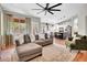 Bright living room with large window, modern ceiling fan, and open floor plan to the kitchen at 4350 E Gatewood Dr, Phoenix, AZ 85050