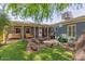 Inviting backyard with fire pit, comfortable seating, mature tree, and outdoor lighting at 445 W 1St St, Mesa, AZ 85202