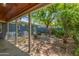View of a covered patio looking out to the backyard with a mature tree and fire pit at 445 W 1St St, Mesa, AZ 85202