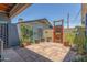 Charming brick patio featuring unique wooden gate and potted plants for backyard enjoyment at 445 W 1St St, Mesa, AZ 85202