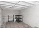 View of an unfinished basement with a rack, exposed ceiling and cinder block walls at 445 W 1St St, Mesa, AZ 85202