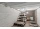 Basement stairs leading to a storage area with block walls and a small window at 445 W 1St St, Mesa, AZ 85202