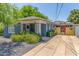Charming single-story home with blue painted brick, mature landscaping, and a welcoming front porch at 445 W 1St St, Mesa, AZ 85202