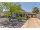 Charming single-story home with blue brick exterior and driveway at 445 W 1St St, Mesa, AZ 85202