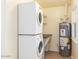 A bright laundry room features a stacked washer/dryer and water heater at 445 W 1St St, Mesa, AZ 85202