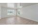 Empty Living room featuring neutral walls, tile flooring, bright windows and ample natural light at 445 W 1St St, Mesa, AZ 85202