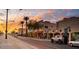 Scenic street view featuring palm trees and charming storefronts at sunset at 445 W 1St St, Mesa, AZ 85202