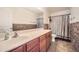 Bathroom with a vanity, a white sink, an expansive mirror, and a shower-tub combination at 45311 W Woody Rd, Maricopa, AZ 85139