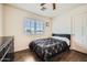 Comfortable bedroom featuring wood-look flooring, a ceiling fan, and neutral decor at 45311 W Woody Rd, Maricopa, AZ 85139