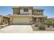 Inviting two-story home featuring a two-car garage and desert landscaping in the front yard at 45311 W Woody Rd, Maricopa, AZ 85139