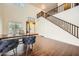 Open-concept foyer featuring high ceilings, wood floors, and a staircase to the upper level at 45311 W Woody Rd, Maricopa, AZ 85139