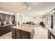 Kitchen area with granite counters, a central island, and dark cabinets at 45311 W Woody Rd, Maricopa, AZ 85139