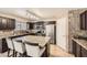 Beautiful kitchen with dark cabinets, granite countertops, stainless steel appliances, and a large island at 45311 W Woody Rd, Maricopa, AZ 85139