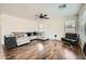Cozy living room with hardwood floors, a ceiling fan, and comfortable seating at 45311 W Woody Rd, Maricopa, AZ 85139