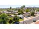 Aerial view of a residential neighborhood with lush greenery, palm trees, and mountain views at 5127 E Tamblo Dr, Phoenix, AZ 85044