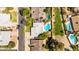 Aerial view showing backyard pool and home's roof and surrounding properties at 5127 E Tamblo Dr, Phoenix, AZ 85044