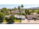 Scenic aerial view of a neighborhood with mature trees and stunning mountain backdrop at 5127 E Tamblo Dr, Phoenix, AZ 85044