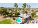 Aerial view of a backyard featuring a sparkling pool, covered patio, and lush greenery at 5127 E Tamblo Dr, Phoenix, AZ 85044