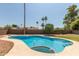 Stunning pool and spa combo with well-maintained concrete and desert landscaping at 5127 E Tamblo Dr, Phoenix, AZ 85044