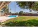 Beautiful backyard featuring a refreshing in-ground pool and grassy lawn at 5127 E Tamblo Dr, Phoenix, AZ 85044