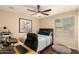 This bedroom has a ceiling fan, desk, and large window at 5127 E Tamblo Dr, Phoenix, AZ 85044
