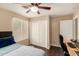 This bedroom features hardwood floors, a ceiling fan, and a desk at 5127 E Tamblo Dr, Phoenix, AZ 85044