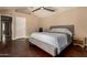 This bedroom features a ceiling fan, and wood floors at 5127 E Tamblo Dr, Phoenix, AZ 85044